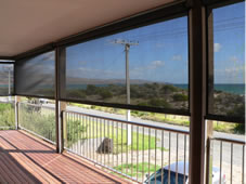 Large graphite ziptrak blinds  half way retracted on the beach front